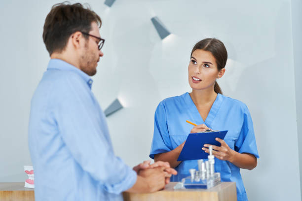 Picture of male patient signing documents in dental clinic